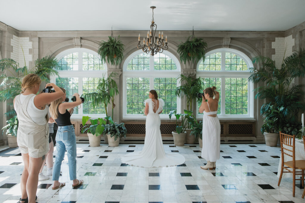Behind the scenes of photographers at a styled shoot 